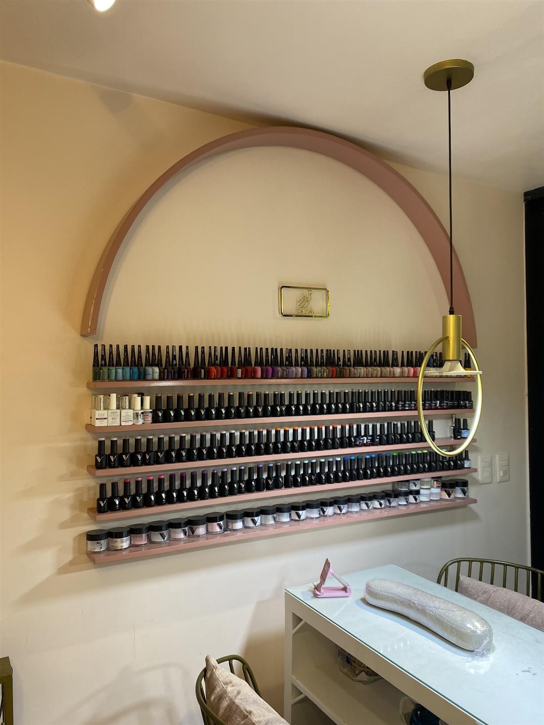 Pared de esmaltes bajo un arco rosado